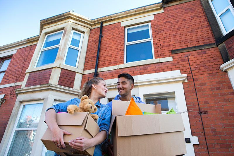 two people holding boxes as they move