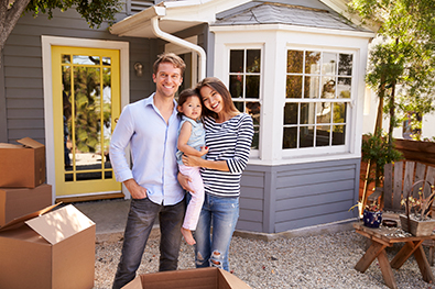 young family of new home owners smiling